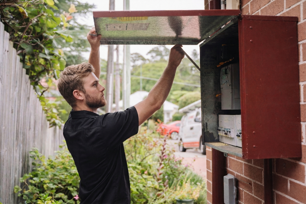 Electrician installing downlights in a Breakfast Point home